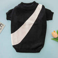Black short-sleeve knit sweater with white diagonal stripe on light blue background