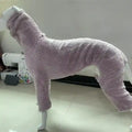 Lavender soft fleece dog onesie displayed on white mannequin indoors with sewing machine background